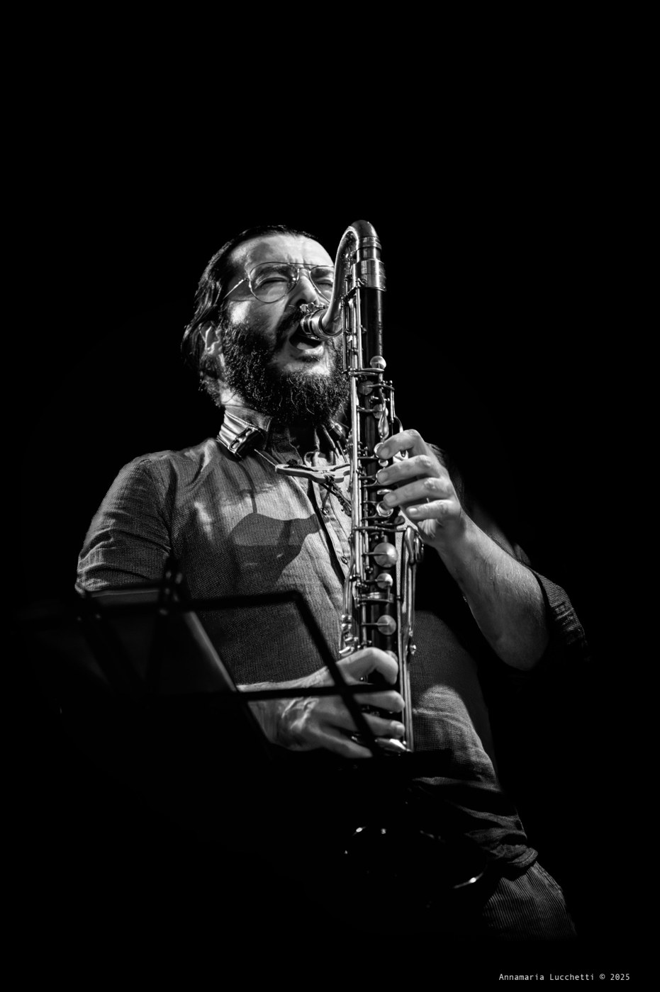 Piero Bittolo Bon playing bass flute in a black and white concert photograph